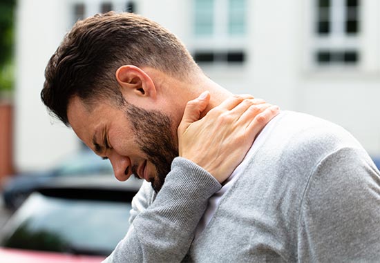 Man experiencing whiplash pain in neck